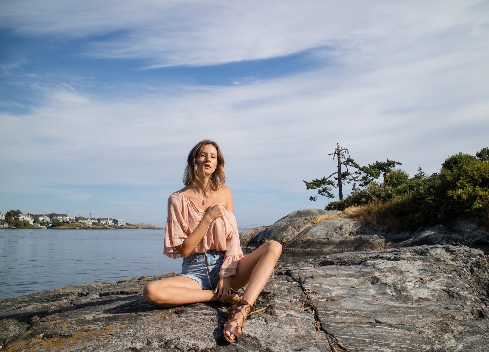 fashion blogger, Alison Hutchinson, is wearing a Zara boho off the shoulder blouse, ksubi denim cutoffs, and gladiator sandals at the beach in Victoria