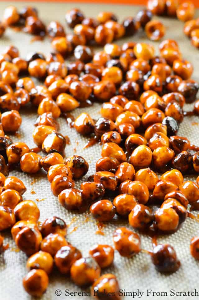 Spiced Candied Hazelnuts spread on a silpat lined baking sheet from Serena Bakes Simply From Scratch.