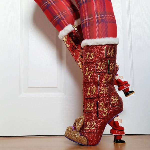 Santa heeled festive red glitter boots being worn with tartan tights