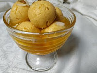 Serving garnished orange rasgulla