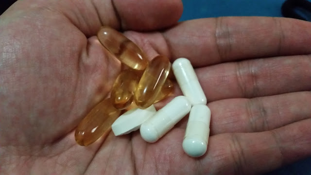 A variety of food supplements placed in the palm