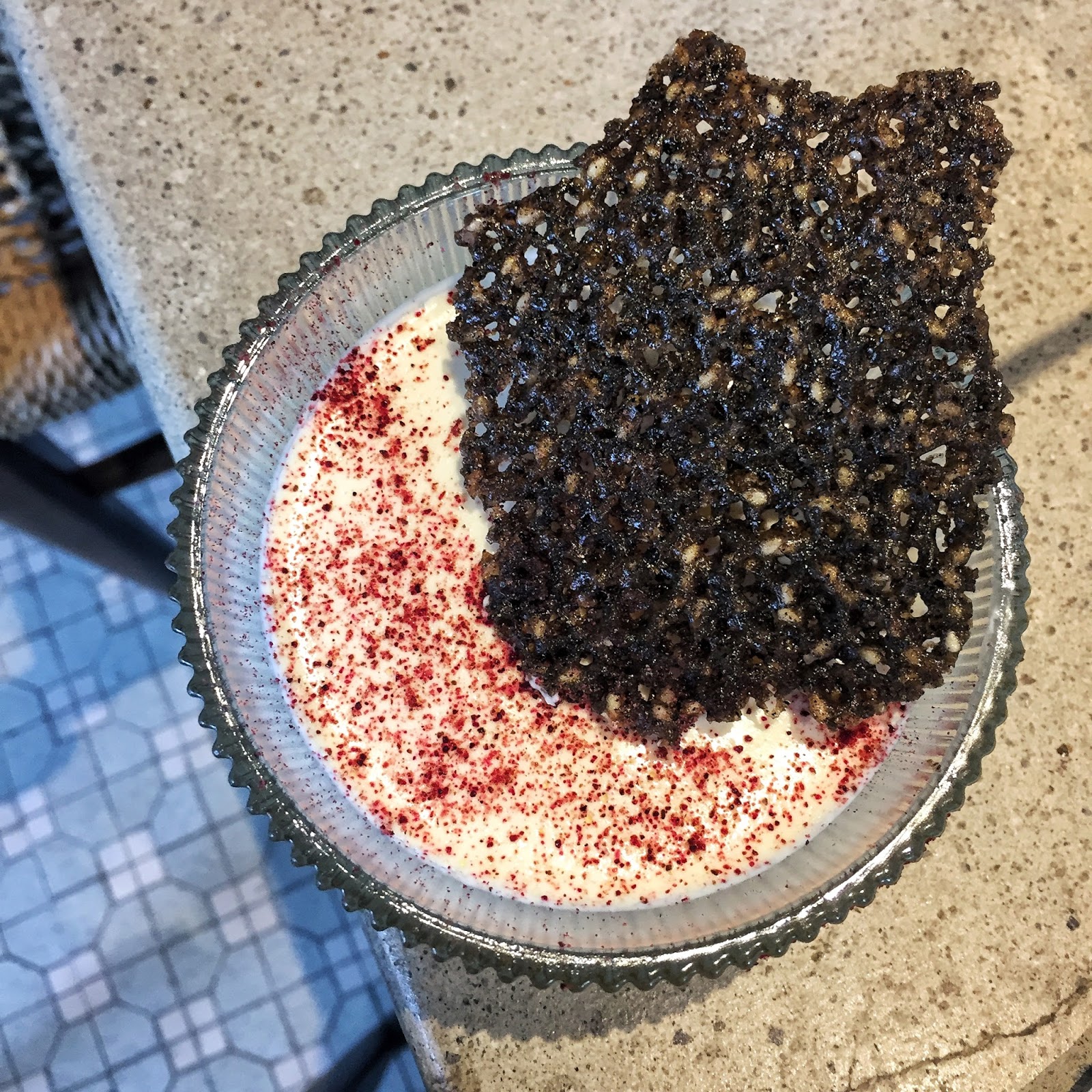 Bowl of creamy yogurt served over a black sesame jam base and