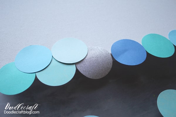 How to make Mermaid fish scales wall art with paper circles in various shades of blue.