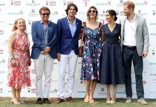 Meghan Markle wore Carolina Herrera dress, Aquazzura 'Deneuve pumps, Birks Bee Chic blue topaz earrings, Tom Ford sunglasses, carries J Crew clutch