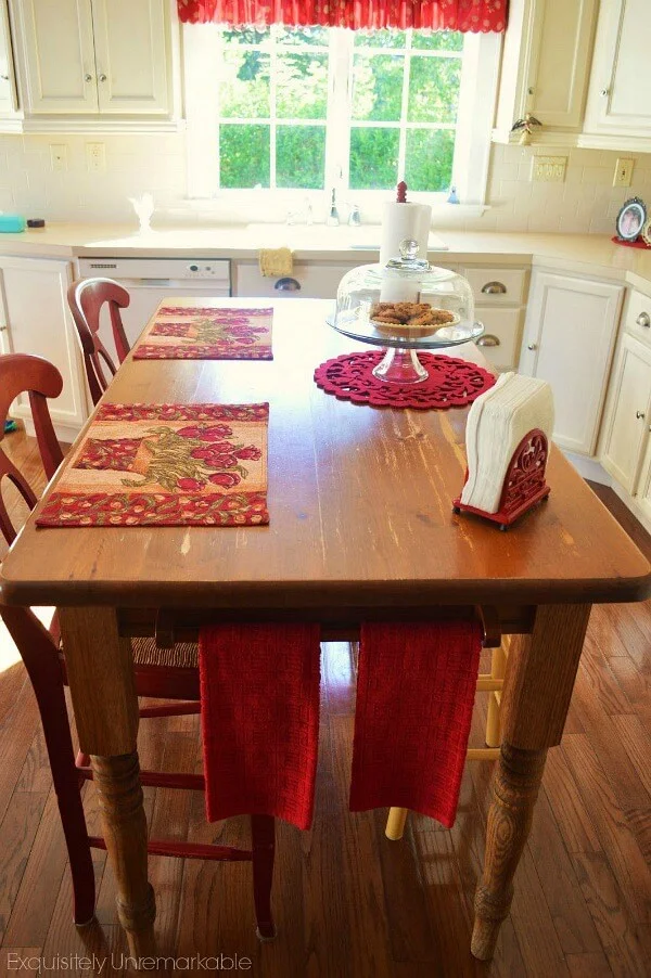 Kitchen table turned island with red bar stools