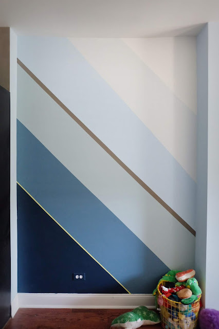 angled hand painted wall stripes in shades of blue