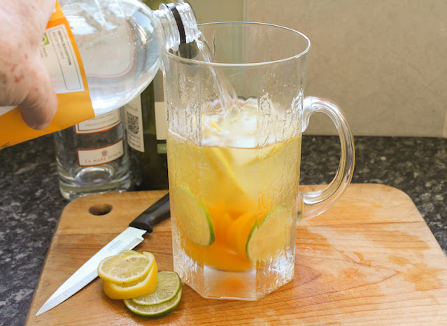 Food Lust People Love: This citrus peach sangria is made with canned peaches, lemons and limes, summer sunshine in a glass so you can enjoy it year round. Make this refreshing favorite for your next family party!