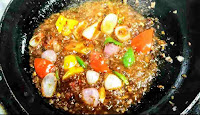 Simmering vegetables like bell peppers capsicum onion