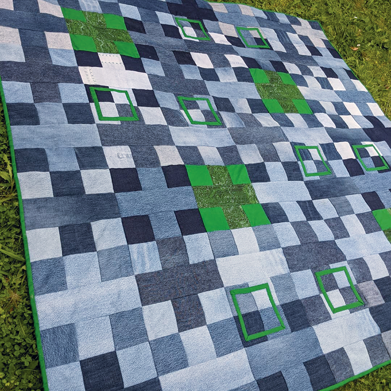 Amy's denim Positively Square quilt with the odd green block