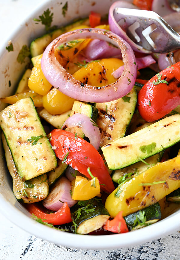 a white bowl with grilled vegetables