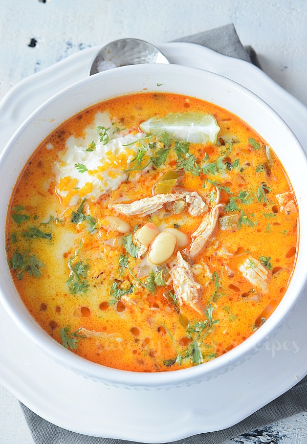 top view of a white bowl with creamy white bean chicken chili