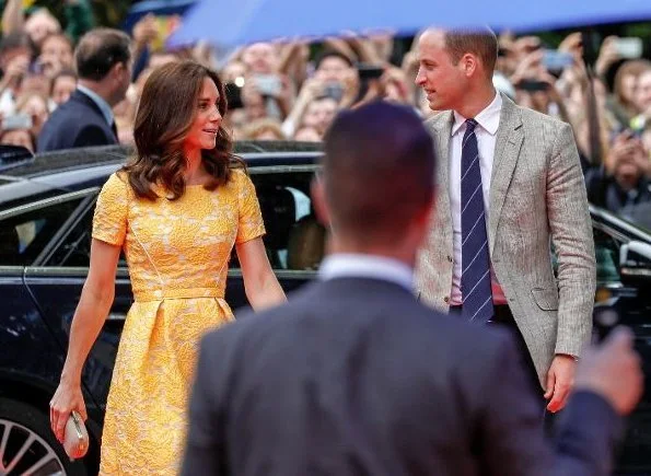 The Duchess wore Jenny Packham Yellow Dress for Heidelberg visit. Kate's wearing her Monsoon Fleur wedges and Oscar de la Renta Pearl Sun Star Button earrings