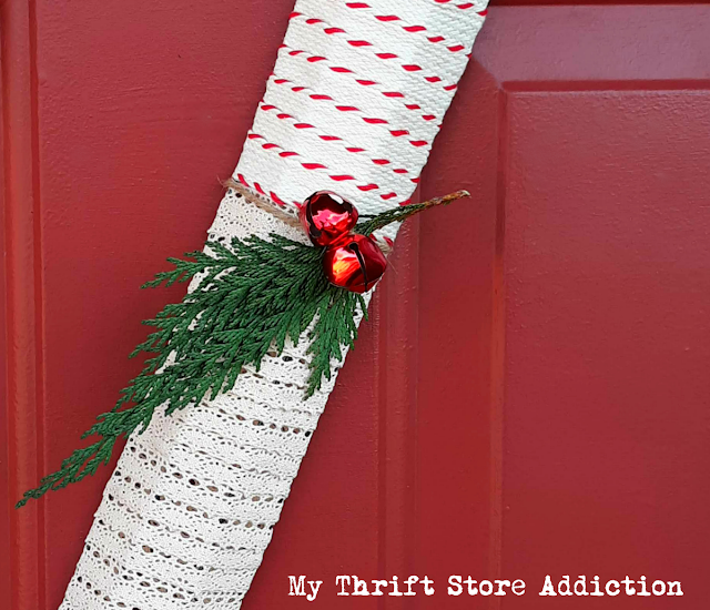 Run to the dollar store to grab a candy cane wire form so you can create one of these farmhouse style wreaths! DIY dollar store candy cane wreath