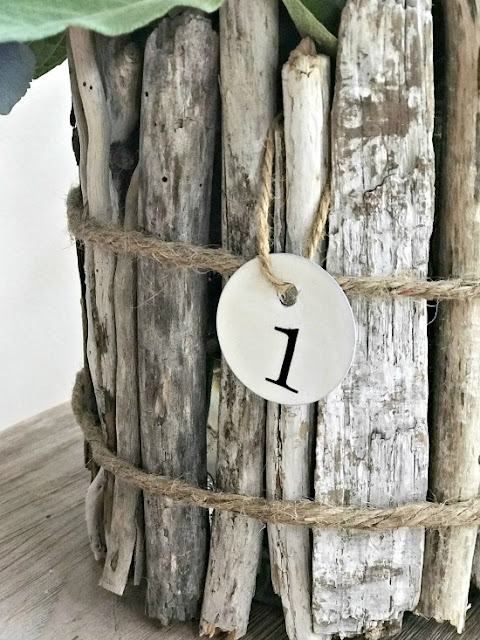 driftwood vase with metal number tag