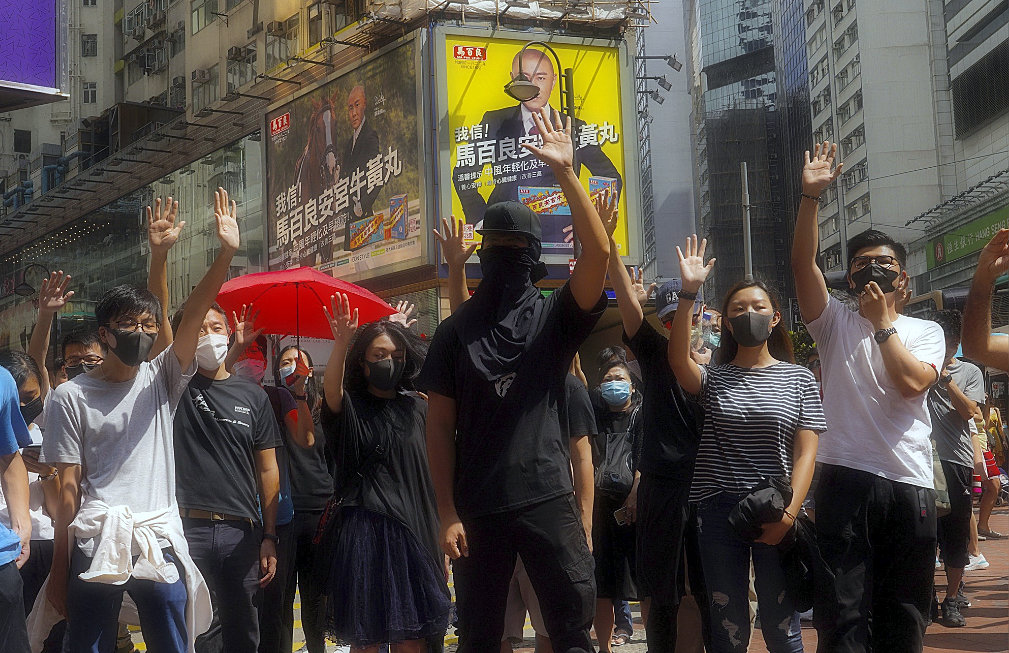 Hong Kong introduces emergency powers to ban face masks in protests