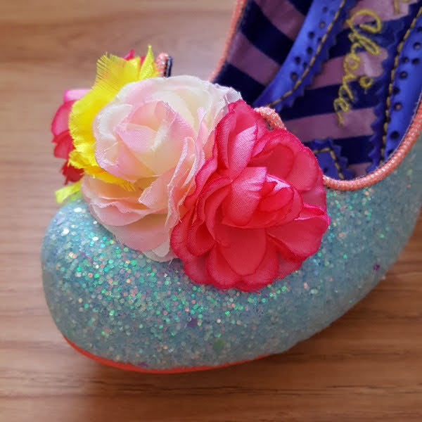 close up of bright flowers on front of glitter shoe