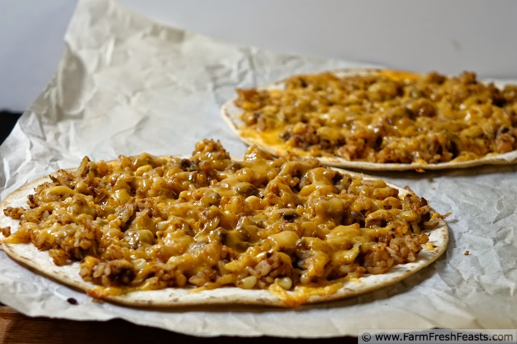 A easy and fast pizza for a family Pizza Night--combining leftover taco meat with vegetables and grains on a tortilla pizza covered with cheese.