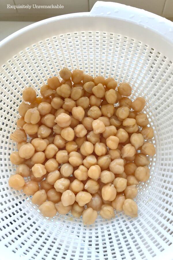 Rinsing Chickpeas in a white strainer