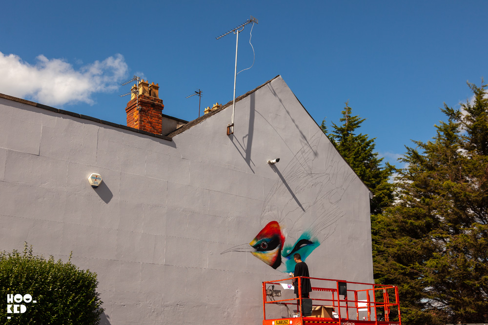 Street artist L7M at work on a Street Art Mural in Cheltenham