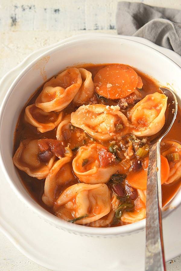 white bowl with cheese tortellini and minestrone soup