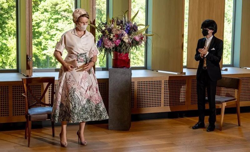 Queen Mathilde wore a beige silk belted printed skirt with embellished point long sleeve shirt from Dries van Noten