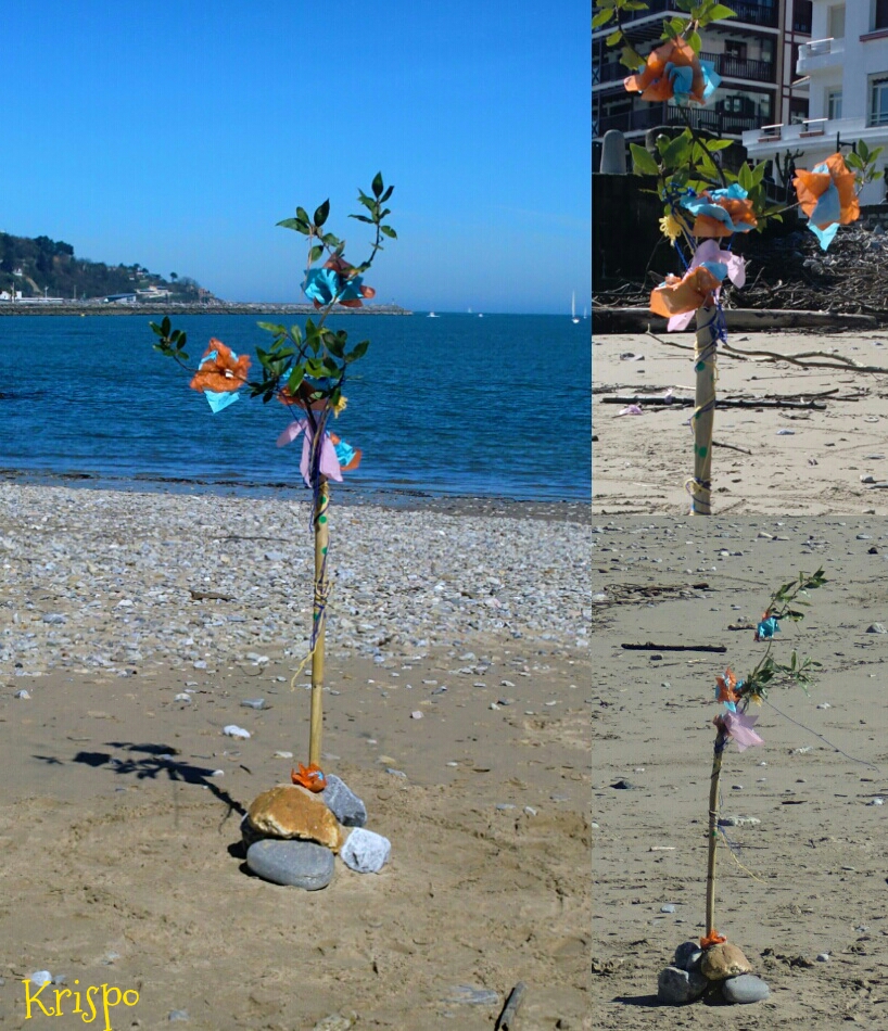 arbol de bambú, flores de papel y lazos en la playa en Hondarribia