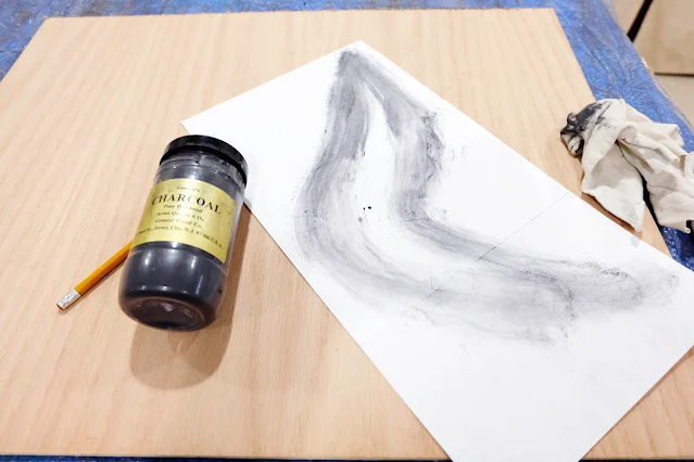 using powdered charcoal to trace shapes