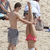 Playful Home and Away star Demi Harman nails a headstand with the help of co-star and beau Alec Snow before they share a kiss by the beach   