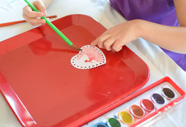 Valentine Suncatchers- Beautiful watercolor heart process art painting project for preschool, kindergarten, or elementary kids. Brighten up a dreary winter day with this pretty, colorful craft!