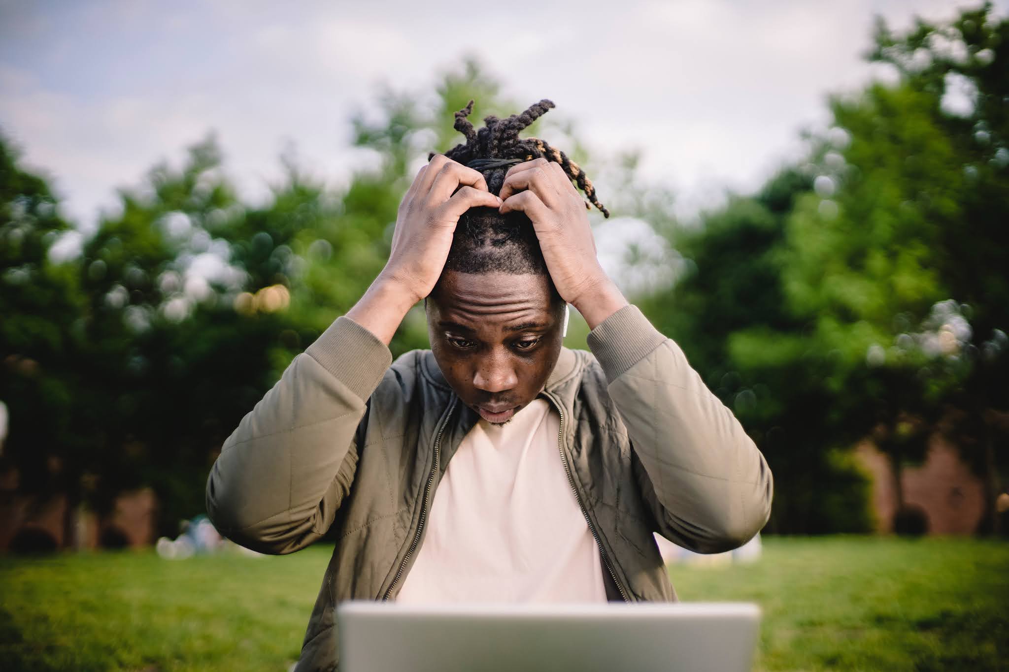 A person with hands on head thinking on how to learn from mistakes