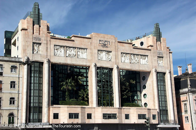 Art Deco Facade, with massive palmtrees in its large front windows.