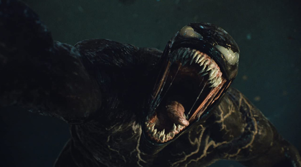Venom (Tom Hardy) prepares to snack on a bad guy in VENOM: LET THERE BE CARNAGE.