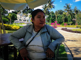 Woman Traveler Sitting In Front Of Beautiful Tropical Garden Park In The Warmth Sunshine At Tangguwisia Village North Bali Indonesia