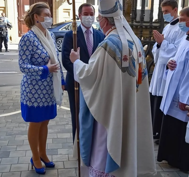 Princess Stephanie wore a pattern blue geo coral midi dress from Boden. Blue pumps