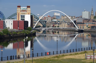 The Millennium Bridge reflected in the River Tyne on a sunny day