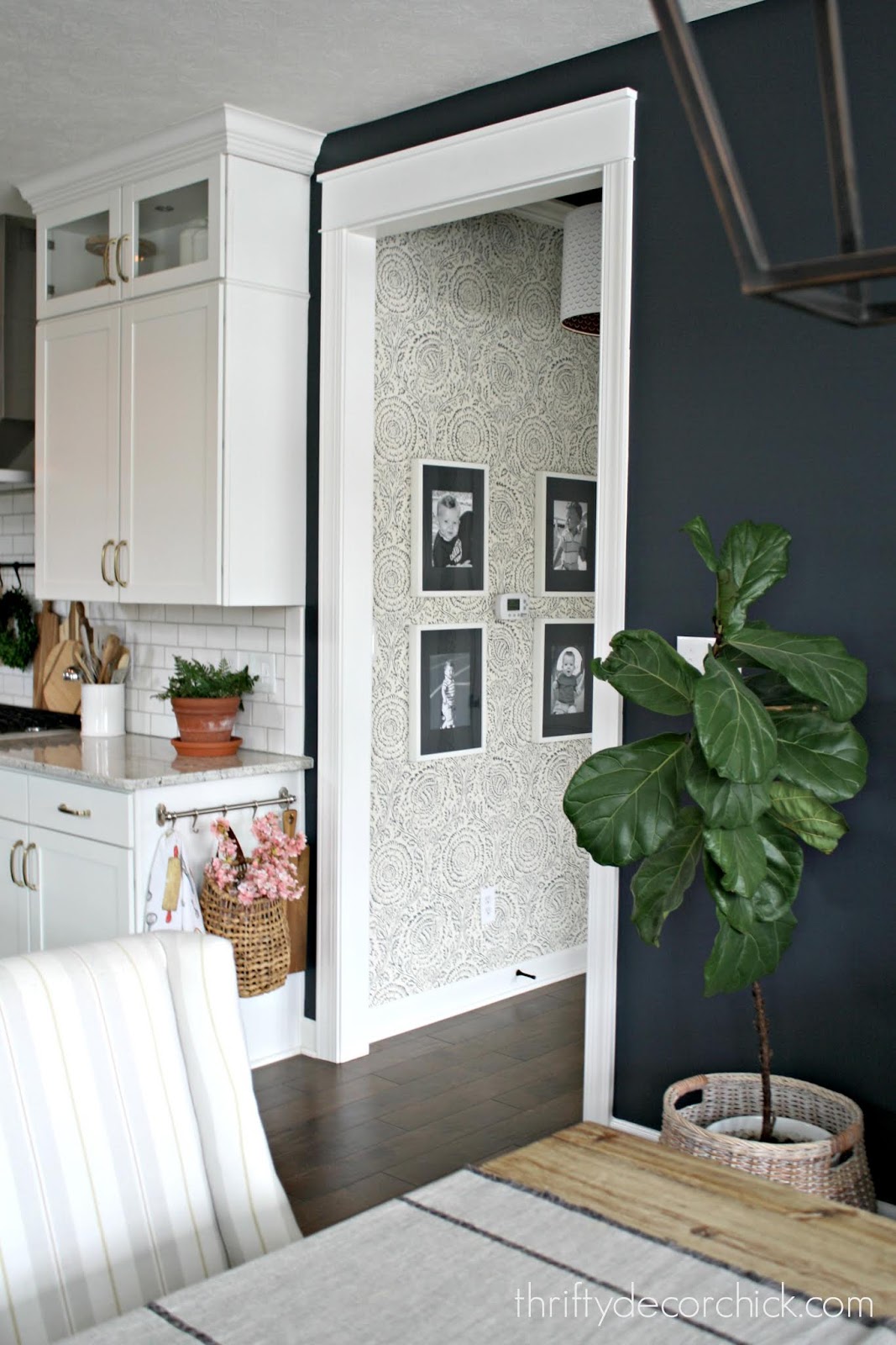 Small hallway with dark blue ceiling and wallpaper