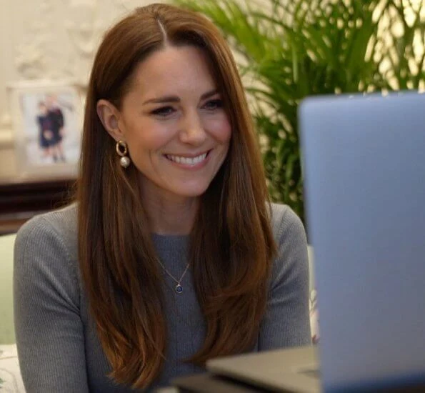 Kate Middleton wore a new fine ribbed knit top from Alexander McQueen, pearl curb chain earrings from Simone Rocha