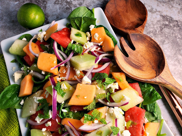 Refreshing Melon Salad:  Refreshingly cool and sweet melons mixed with onions and feta top a bed of baby spinach and doused with the most flavorful citrus garlic vinaigrette make one heck of a side dish! - Slice of Southern