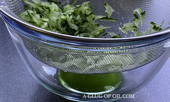Draining the grated cucumber for tzatziki Draining the grated cucumber
