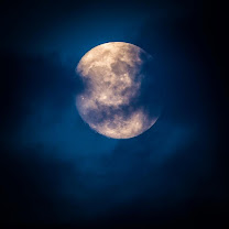 full moon seen through the clouds