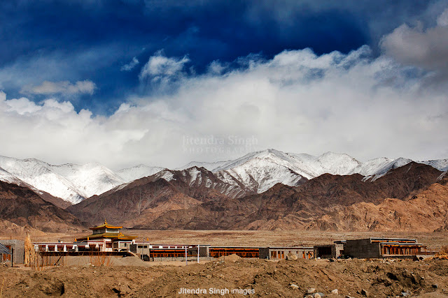 After a Great PHOTO JOURNEY from Barsana Holi, now Jitendra is taking us to Leh through his phenomenal Photographs.  All these photographs were shot at Leh in the month of Feb last year (Feb, 2012). Let's check out this Photo Journey and enjoy wonderful landscapes, people and culture of Leh.Leh was the capital of the Himalayan kingdom of Ladakh, now the Leh District in the state of Jammu and Kashmir, India. Leh is the second largest district in the country (after Kutch, Gujarat) in terms of area.Over the time, Leh has become one of the hot destination for Tourists and Photographers. We always see wonderful photographs from Leh and all these motivate almost everyone to visit Leh, click these wonderful landscapes and come back with great memories to cherish for. At Photo Journey, we planned many Leh trips and there are some great plans in 2013 as well. Some of the passionate Photographers have come together to plan a great trip to Leh through Spiti Valley and some of the passionate Bloggers & Travellers are also joining. Above photograph shows a wonderful frame from a market - vehicles moving around and people walking on the footpath. For most of the folks, it's hard to imagine a vacation at Leh during winters. But trends are changing and now people love exploring Leh during winters as well. Above photograph shows one of the views from Leh - snow covered courtyard. Ladakh is a region of India in the state of Jammu and Kashmir which lies between the Kunlun mountain range in the north and the main Great Himalayas to the south , inhabited by people of Indo-Aryan and Tibetan descent. It is one of the most sparsely populated regions in Jammu and Kashmir.Leh also presents great opportunities to explore different cultures, colors and various unique things all around.It includes the Baltistan (Baltiyul) valleys, the Indus Valley, the remote Zangskar, Lahaul and Spiti to the south, Aksai Chin and Ngari, including the Rudok region and Guge, in the east, and the Nubra valleys to the north.Since Ladakh is a part of strategically important Jammu and Kashmir, the Indian military maintains a strong presence in the region. The largest town in Ladakh is Leh. It is one of the few remaining abodes of Buddhism in South Asia, including the Chittagong Hill Tracts, Bhutan and Sri Lanka... a majority of Ladakhis are Tibetan Buddhists and the rest are mostly Shia Muslims. Some Ladakhi activists have in recent times called for Ladakh to be constituted as a union territory because of its religious and cultural differences with predominantly Muslim KashmirThe economy of Ladakh rests on three pillars: the Indian Army, tourism, and civilian government in the form of jobs and extensive subsidies. Agriculture, the mainstay only one generation ago, is no longer a major portion of the economy, although most families still own and work their land. In past, Ladakh enjoyed a stable and self-reliant agricultural economy based on growing barley, wheat and peas and keeping livestock, especially yaks, cows, dzos  sheep and goats. Animals are scarce and water is in short supply. The Ladakhis developed a small-scale farming system adapted to this unique environment. The land is irrigated by a system of channels which funnel water from the ice and snow of the mountains. The principal crops are barley and wheat. Rice was previously a luxury in the Ladakhi diet, but, subsidised by the government, has now become a cheap staple.In the past, Ladakh gained importance from its strategic location at the crossroads of important trade routes, but since the Chinese authorities closed the borders with Tibet and Central Asia in the 1960s, international trade has dwindled except for tourism.  