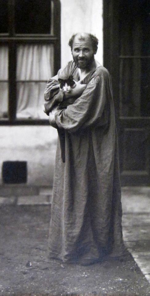 men holding cats, men wearing cats