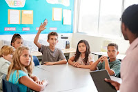 6 students at classroom table with teacher