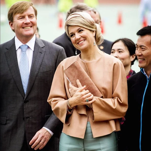 Queen Maxima and King Willem-Alexander of The Netherlands visit the Sino-Dutch Diary Development Center on October 25, 2015 in Beijing, China