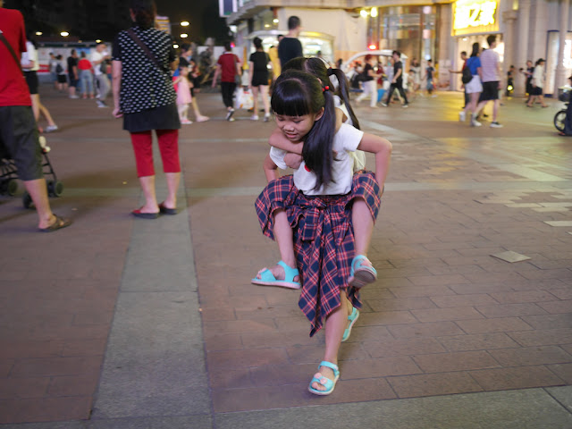 girl giving another girl a piggyback ride