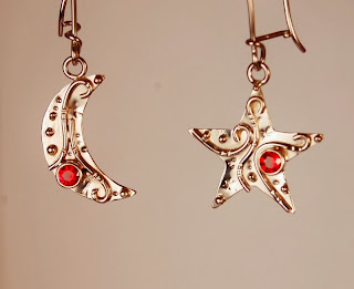 Moon shaped and star shaped pair of earrings with orange stones