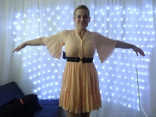 woman in white dress with background of fairy lights