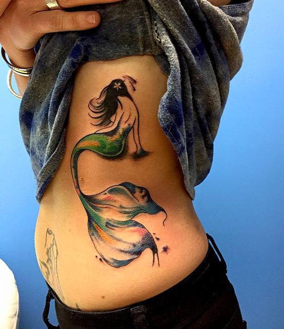 Mermaid tattoos on ribcage for girl