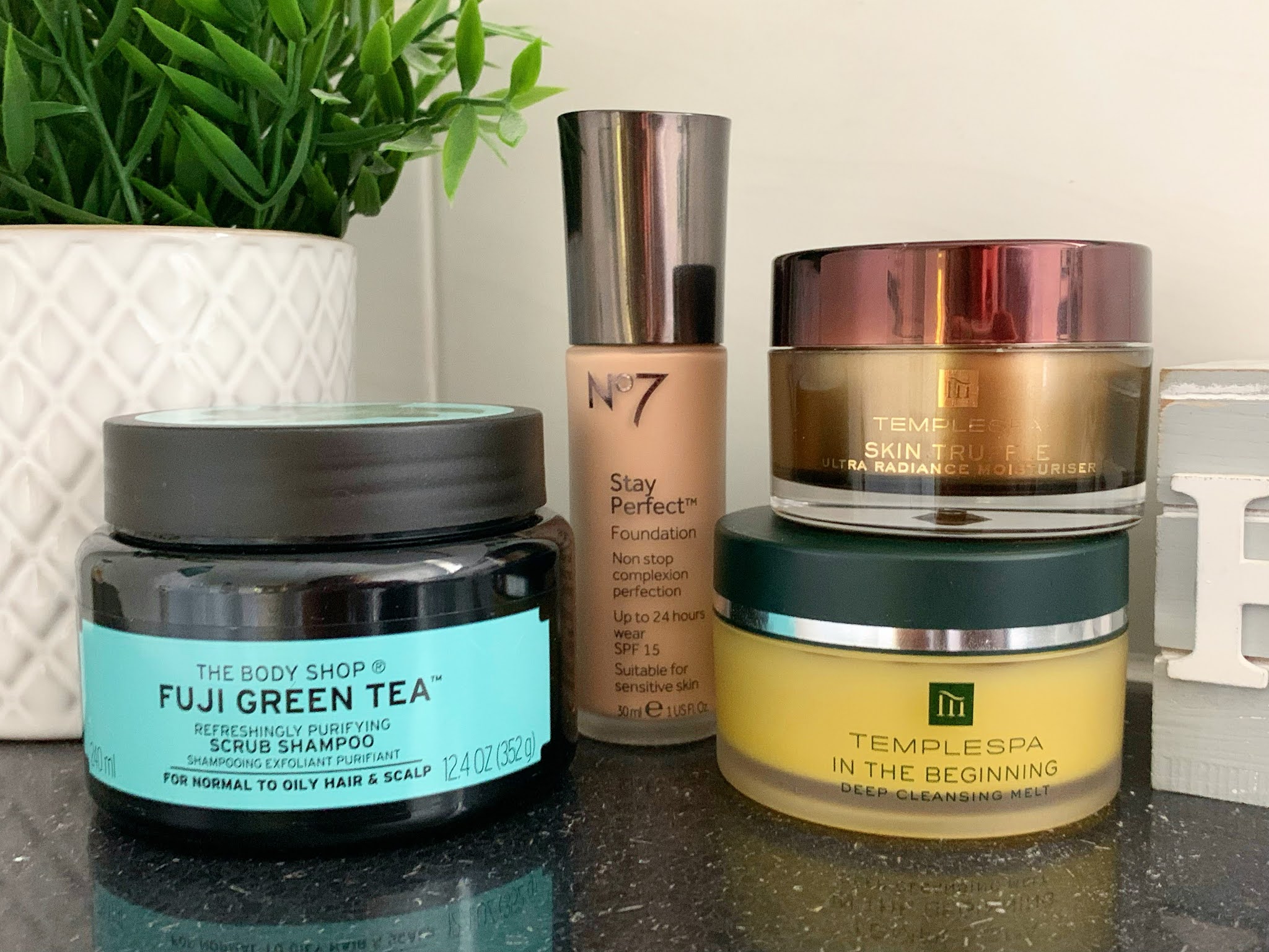 What I've Been Loving in Summer Beauty products lined up on a shelf
