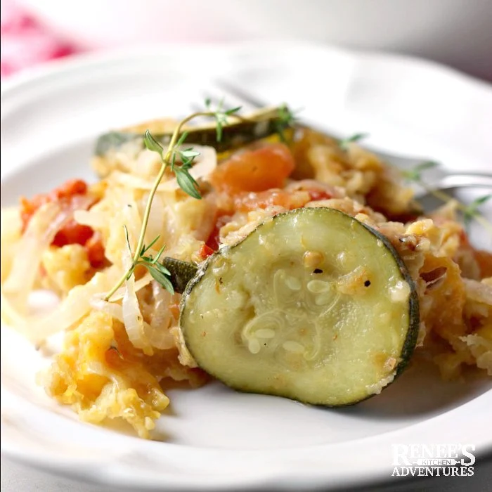 A serving of Zucchini Casserole by Renee's Kitchen Adventures on a white plate with a fork